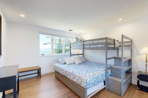 a bedroom with a bunk bed and a desk at Lakeshore Retreat in Gilford