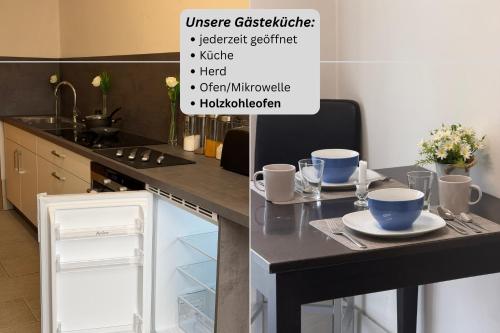 a kitchen with a table with two cups on it at Hotel Rühen, 24 Stunden Check in, Küche, kostenfreie Parkplätze in Rühen