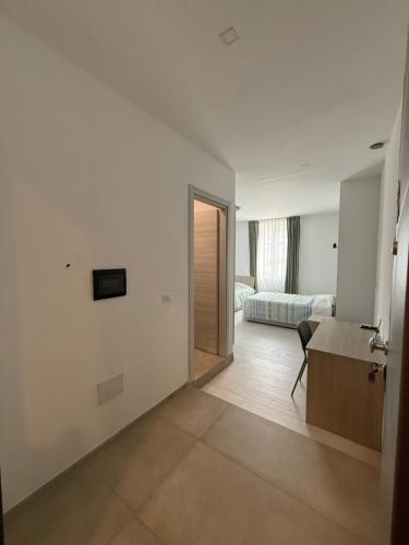 a hotel room with a desk and a bed at La Locanda del Giardino in Lentate sul Seveso