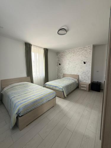 a bedroom with two beds and a stone wall at La Locanda del Giardino in Lentate sul Seveso