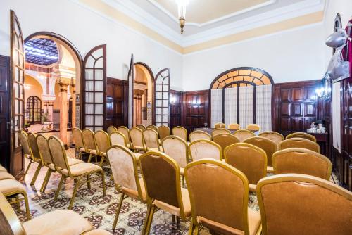 a room with a bunch of chairs in it at Hotel Majestic in Barranquilla