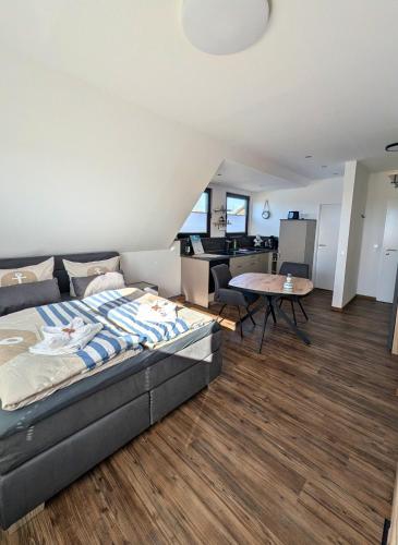 a bedroom with a bed and a living room at Haus Ausreißer 2 - Hafennest in Bensersiel
