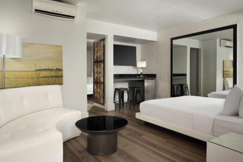 a bedroom with a white bed and a white couch at The Clarendon Hotel & Spa, BW Signature Collection in Phoenix