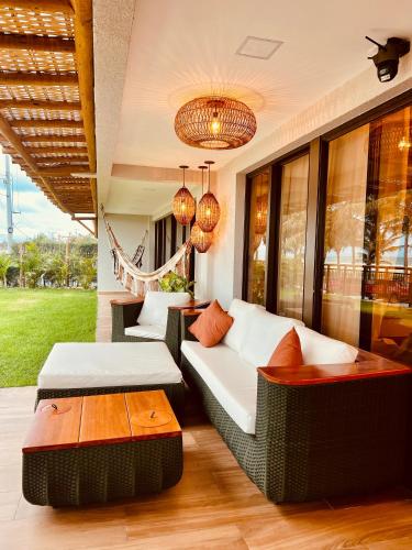 a living room with a couch and a table at House Paraíso Flecheiras in Trairi