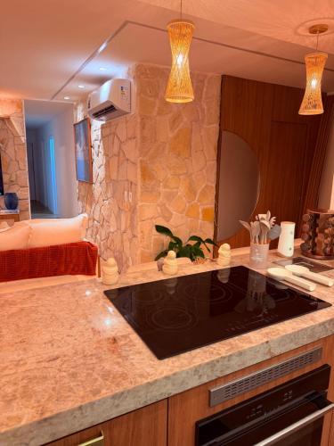 a kitchen with a counter top with a sink at House Paraíso Flecheiras in Trairi