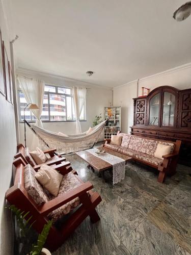 a living room with a hammock in the middle of it at Quarto Privativo na AvBeira mar - Apto familiar in Fortaleza