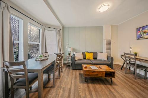 a living room with a table and a couch at Modern Deluxe Kitchen, King Bed, Laundry, DT Renton close to Valley Med & SeaTac in Renton