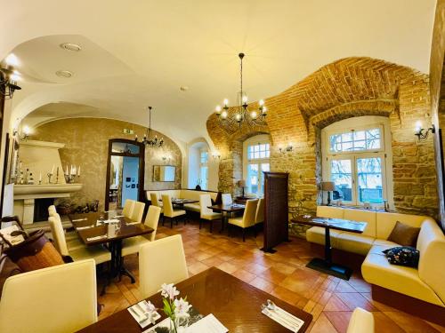 a living room filled with furniture and a brick wall at Hotel Zámek Berchtold in Kunice