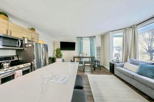 a kitchen and living room with a large counter top at DT Stylish & Newly Renovated Home 2BR Sea Tac 6 Miles with AC in Renton