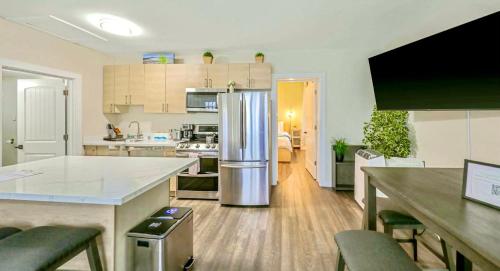 a kitchen with a stainless steel refrigerator in a room at DT Stylish & Newly Renovated Home 2BR Sea Tac 6 Miles with AC in Renton