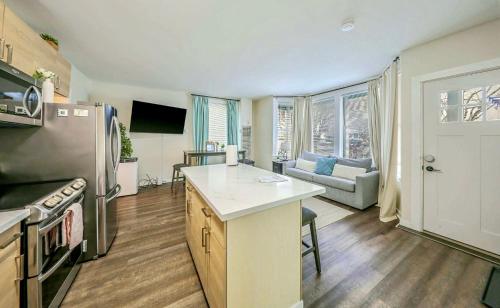 a kitchen with a refrigerator and a table in a room at DT Stylish & Newly Renovated Home 2BR Sea Tac 6 Miles with AC in Renton