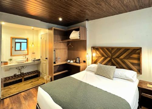 a bedroom with a bed and a bathroom with a sink at Hm Montes Central in Cusco