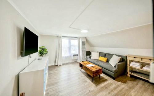 a living room with a couch and a table at Chic, Cozy & New Prime location with AC, Street Parking #4 in Renton