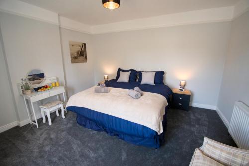 a bedroom with a bed with two teddy bears on it at New! Luxury 4 Bedroom Detached House - Central Baslow in Baslow
