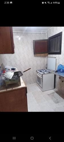 a kitchen with a stove and a counter top at one room in Alexandria