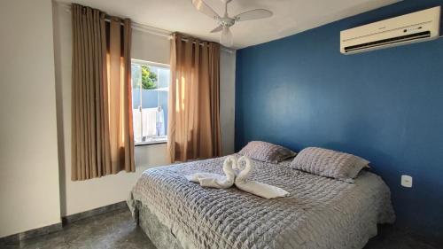 a bedroom with a bed with two towels on it at Casa Cris cabo frio in Cabo Frio