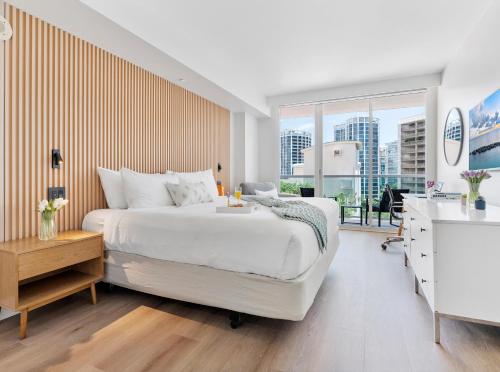 a bedroom with a white bed and a large window at Private Oasis at Arya in Miami