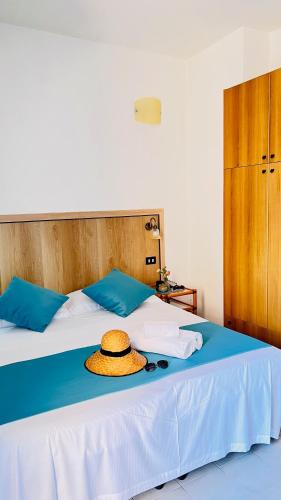a hat sitting on top of a bed at Zeeva Hotel and Resort in Torre Dei Corsari