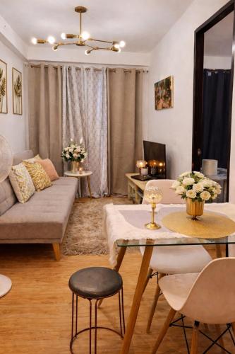 a living room with a couch and a table at Super Cozy Condo Davao in Davao City