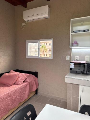 a small room with a bed and a window at Don Isidro in Miramar