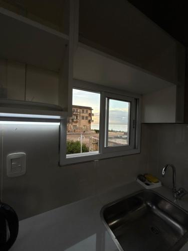 a kitchen with a sink and a window at Don Isidro in Miramar