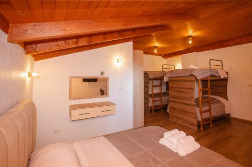a bedroom with a bed and two bunk beds at Bellway Guest House in Shkodër