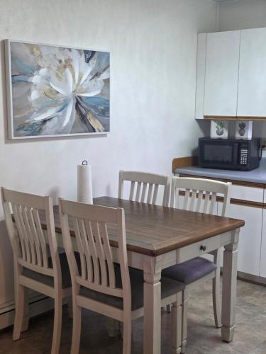 a kitchen with a wooden table and chairs at RJN in Fairbanks