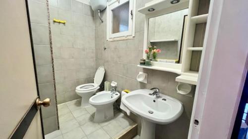 a small bathroom with a toilet and a sink at Zeeva Hotel and Resort in Torre Dei Corsari
