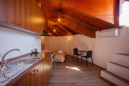a kitchen with a sink and a table in a room at Bellway Guest House in Shkodër