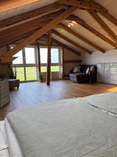 a large room with a bed and a couch at Lütt Marschkieker in Langenhorn