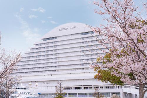a large white building with a sign on it at Kobe Meriken Park Oriental Hotel in Kobe