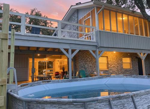 a house with a large pool in front of it at Tequila Sunrise hot tub lake view firepit pool in Canyon Lake