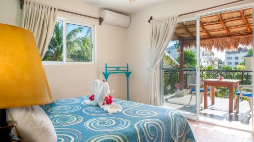 a bedroom with a bed with a stuffed animal on it at Abbey del Sol - Tropical Escape Near Beach in Puerto Morelos in Puerto Morelos