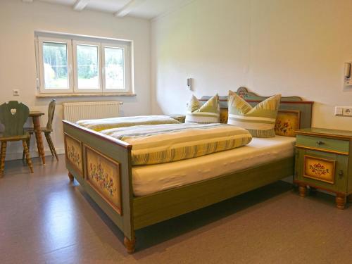 a bedroom with a large bed with a wooden frame at Sugar Farm Weideblick in Sankt Georgen im Schwarzwald