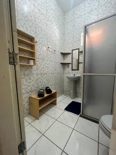 a bathroom with a shower and a toilet and a sink at Vila das Estrelas - Guesthouse in Lençóis