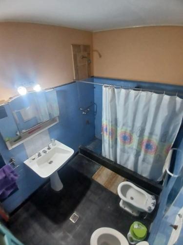 a bathroom with a sink and a toilet and a shower at La Casona Hostel in Bermejo