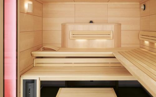 a small wooden sauna with a bench in it at Appartement Schmittenblick in Zell am See