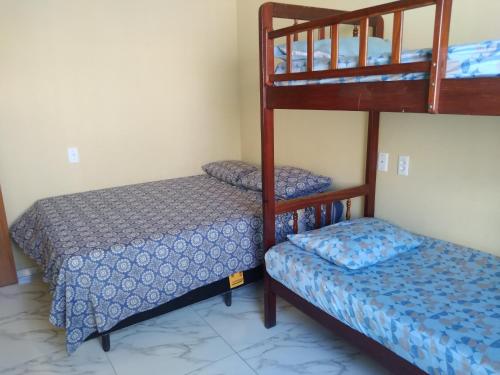 a bedroom with two bunk beds and a bed at Casa Selma Ubajara in Ubajara