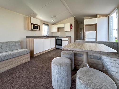 a kitchen and living room with a table and chairs at The Rochester - Uk51003 in Eastchurch