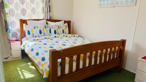 a childs bedroom with a crib in a room at Tranquil Haven Retreat in Hamilton
