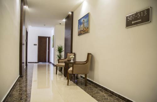a hallway with a waiting room with a table and chairs at Sulaf Luxury Hotel in Amman