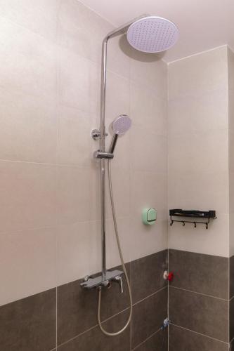 a shower with a shower head in a bathroom at Central Phu Quoc Villa in Phú Quốc