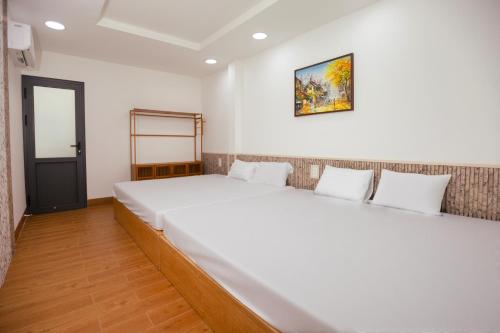 a bedroom with a large white bed in a room at Central Phu Quoc Villa in Phú Quốc