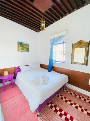 a bedroom with a bed and a window at Morocco PALACE in Chefchaouen