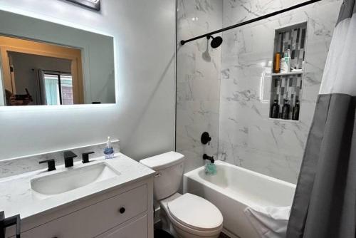 a bathroom with a sink and a toilet and a tub at Sunny Delight Home Near Airport in Hollywood
