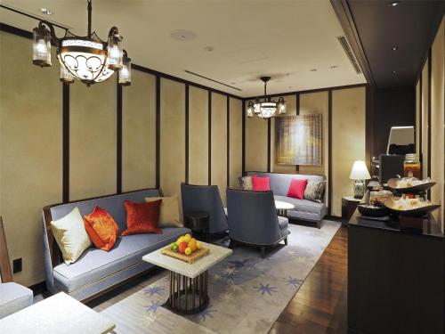 a living room with a couch and chairs and a table at Dhawa Yura Kyoto in Kyoto
