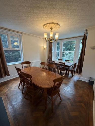 a dining room with a wooden table and chairs at Spectacular Period Property Located In Leicester in Leicester