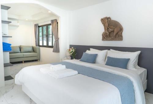 a bedroom with a large white bed in a room at Brickotel Naithon Beach in Nai Thon Beach