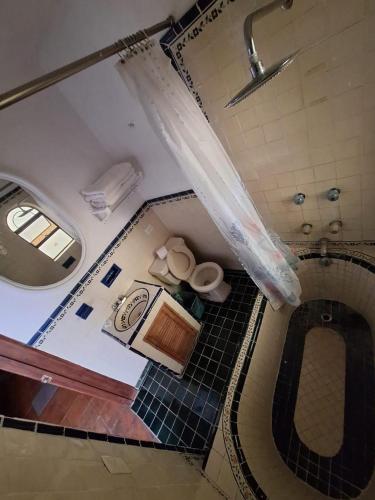 an overhead view of a bathroom with a toilet and a sink at Casa Mesones in San Miguel de Allende