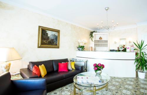 a living room with a couch and a glass table at Hotel Giesing in Munich